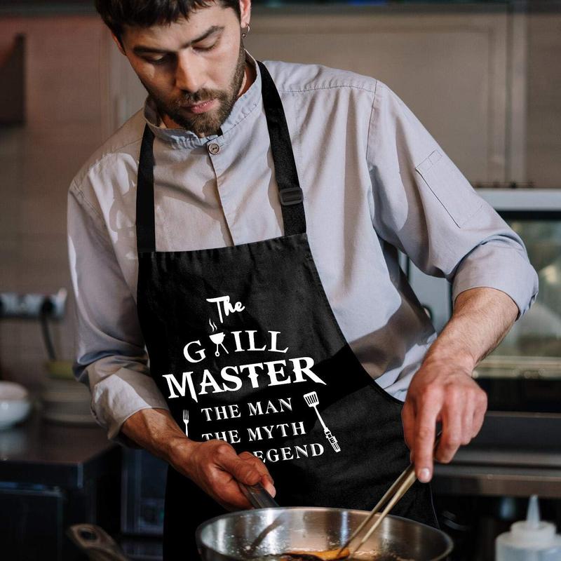 Funny Aprons for Men - The Grill Master, The Man The Myth The Legend - Cooking Grilling BBQ Chef Apron for a Husband, Dad Gifts,  Oil Proof Black Apron with 2 Pockets